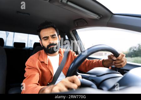 Displeased Middle Eastern Driver Man Driving Having Issue With Automobile Stock Photo