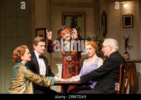 the seance - l-r: Serena Evans (Mrs Bradman), Charles Edwards (Charles Condomine), Angela Lansbury (Madame Arcati), Janie Dee (Ruth Condomine), Simon Jones (Dr Bradman) in BLITHE SPIRIT by Noel Coward at the Gielgud Theatre, London W1  18/03/2014  design: Simon Higlett  lighting: Mark Jonathan  director: Michael Blakemore Stock Photo