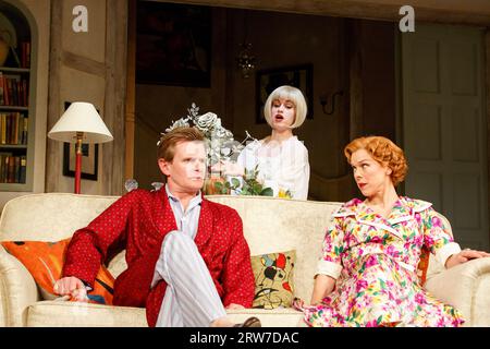 l-r: Charles Edwards (Charles Condomine), Jemima Rooper (Elvira), Janie Dee (Ruth Condomine) in BLITHE SPIRIT by Noel Coward at the Gielgud Theatre, London W1  18/03/2014  design: Simon Higlett  lighting: Mark Jonathan  director: Michael Blakemore Stock Photo