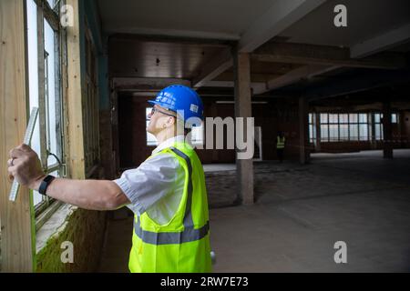 Architect working on building plans, West Sussex, England Stock Photo