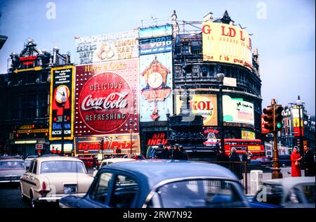 Piccadilly Circus London 1967, with signage advertising Coca Cola, Skol,Guinness and Bulova watches Stock Photo