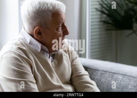 Sad elderly man look in distance thinking Stock Photo