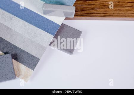 Samples of materials for interior design. Fabric wallpaper, samples of artificial stone, wood. Stock Photo