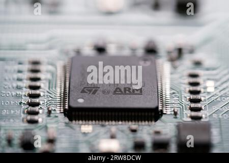 ARM company logo seen on microchip wich is soldered on a Printed Circuit Board (PCB).  Selective focus. London, United Kingdom, September 17, 2023 Stock Photo