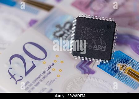 ARM ST32 chip placed on 20 pounds banknote. Concept. Selective focus. London, United Kingdom, September 17, 2023 Stock Photo
