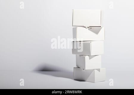 Stack of cardboard gift boxes with copy space over white background Stock Photo