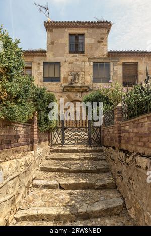 old palatial house with stone shield on the facade in the town of San Esteban de Gormaz, Province of Soria, Autonomous Community of Castile y Leon. Stock Photo