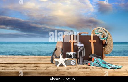 Men's beach clothes and accessories on wooden table Stock Photo