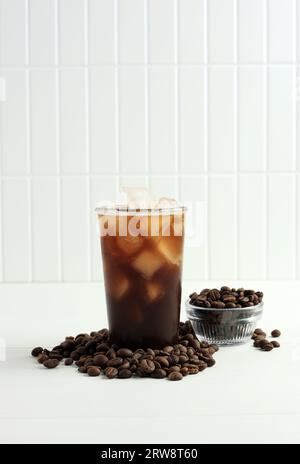 Cold Ice Coffee with Coffee Beans on White Background, Copy Space for Text Stock Photo