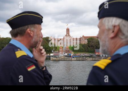 Kiel, Germany. 14th Sep, 2023. Crew members stand on the deck of the sail training ship 'Gorch Fock'. The Mürwik Naval School can be seen in the background. The regular crew of the Navy's sail training ship 'Gorch Fock' is not yet complete. The crew currently includes 90 women and men, 130 are ideal, according to Navy sources. Credit: Marcus Brandt/dpa/Alamy Live News