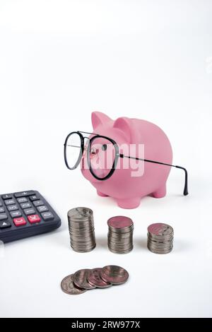 Pink piggy bank with glasses and calculator on white background Stock ...