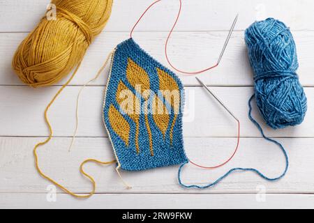 The process of knitting a hat with circular knitting needles using the short rows method Stock Photo
