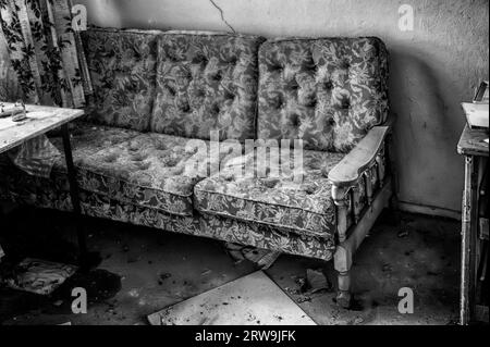 Old sofa in an abandoned building Stock Photo