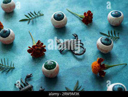 colorful halloween pattern with eyeballs, scorpions and french marigolds Stock Photo