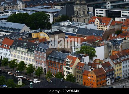 A view of old colorful buildings on Torvegade street in Christianshavn , Copenhagen, Denmark.Church of Our Saviour Stock Photo