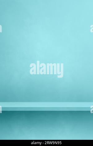 Empty shelf on an aqua blue concrete wall. Background template scene. Vertical mockup Stock Photo