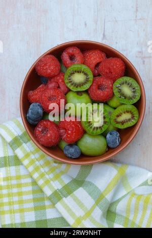 Fruits in shell, raspberries, blueberries, minikiwi Stock Photo