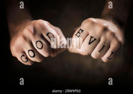 Man with Good and Evil fake tattoos Stock Photo