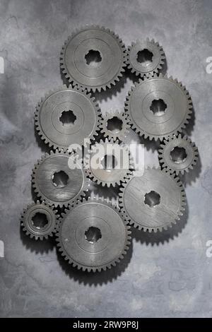Old metallic cog gear wheels on grey background Stock Photo
