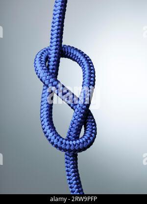 Blue rope with figure of eight stopper knot Stock Photo