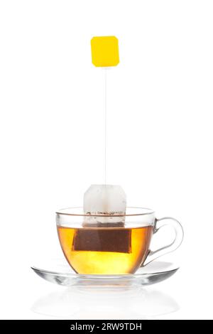 Cup of tea with tea bag (blank label) inside isolated on white background Stock Photo