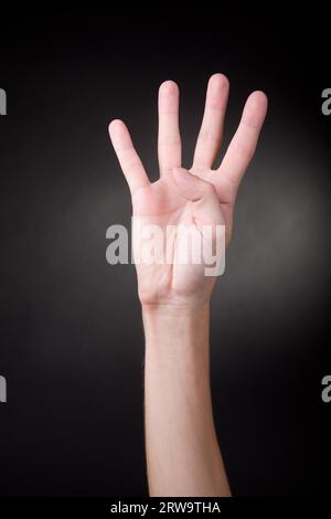 Number four. Human hand showing four fingers Stock Photo