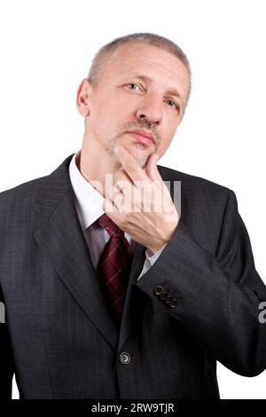 Mature businessman thinking and holding hand on his chin Stock Photo