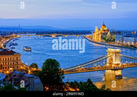 Budapest cityscape in the evening with illuminated Chain Bridge and Margaret Bridge over Danube river and Hungarian Parliament Building Stock Photo