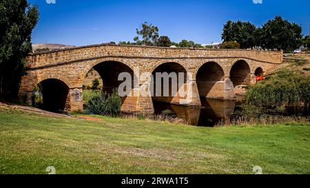 The iconic Richmond Bridge on bright sunny day. Richmond, Tasmania, Australia. Australia's oldest bridge made of stone was built in 1823 Stock Photo