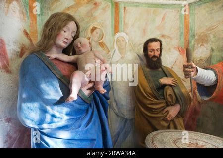 The circumcision of Jesus in the temple. Representation in figures of terracotta with real hair and frescoes by the famous Renaissance artist Stock Photo