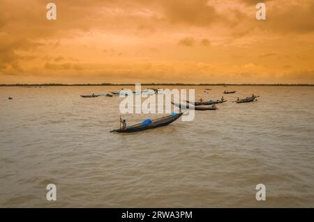 Sunderban, Bangladesh, circa July 2012: Photo of native people in wooden boats on river and fishing in Sunderban, Bangladesh. Documentary editorial Stock Photo