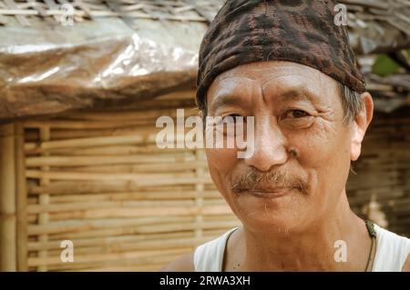 Damak, Nepal, circa May 2012: Native man with brown cap on his head and with moustache at Nepali refugee camp in Damak, Nepal. Documentary editorial Stock Photo