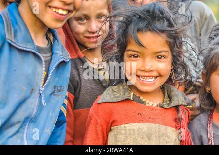 Dolpo, Nepal, circa May 2012: Small girl with brown hair and beautiful brown eyes wears earrings in Dolpo, Nepal. Documentary editorial Stock Photo