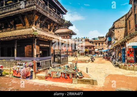 Bhaktapur, Nepal, circa June 2012: Photo of old buildings mostly made of bricks and marketplace in centre of square in Bhaktapur, Nepal. Documentary Stock Photo