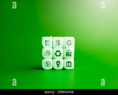 Environmental, social, and corporate governance (ESG), environment sustainable for save the earthconcept. Acronym text 'ESG' and icons on white cube b Stock Photo