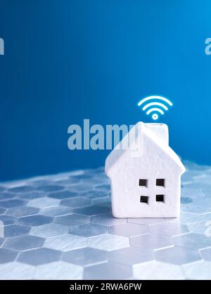 Home Wifi signal, smart home control and automation system technology, digital wireless online, work from home internet connection. Wifi house model o Stock Photo