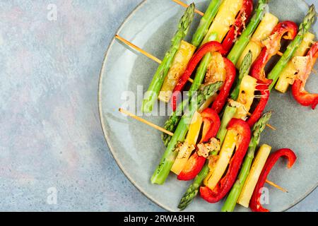 Shish kebabs with bell peppers, green asparagus, cheese. Copy space. Stock Photo