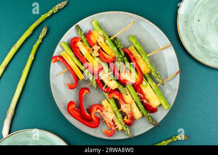 Colorful kebabs with bell peppers, green asparagus, cheese. Summer barbecue food. Flat lay Stock Photo