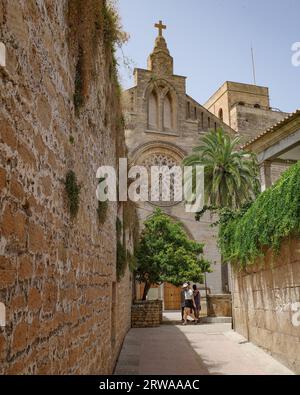 Alcudia, Spain - 9 July, 2023: Sant Jaume Church and castle walls, Alcudia, Mallorca Stock Photo