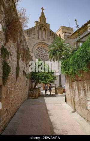 Alcudia, Spain - 9 July, 2023: Sant Jaume Church and castle walls, Alcudia, Mallorca Stock Photo