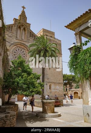 Alcudia, Spain - 9 July, 2023: Sant Jaume Church and castle walls, Alcudia, Mallorca Stock Photo