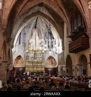 Alcudia, Spain - 9 July, 2023: Sunday service at the Sant Jaume Church in old town Alcudia, Mallorca Stock Photo