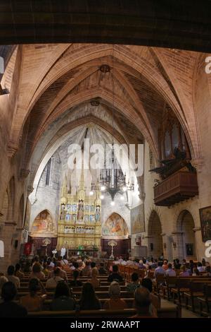 Alcudia, Spain - 9 July, 2023: Sunday service at the Sant Jaume Church in old town Alcudia, Mallorca Stock Photo