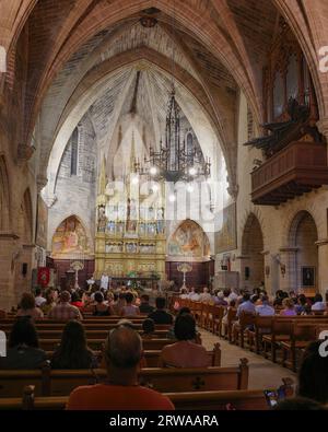 Alcudia, Spain - 9 July, 2023: Sunday service at the Sant Jaume Church in old town Alcudia, Mallorca Stock Photo