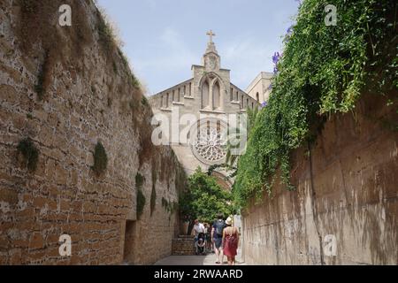 Alcudia, Spain - 9 July, 2023: Sant Jaume Church and castle walls, Alcudia, Mallorca Stock Photo