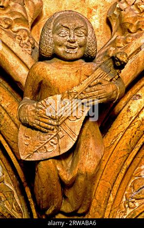 Beverley Minster, Medieval carving, carved stone musician, music, musical,  stringed instrument, Yorkshire, England Stock Photo