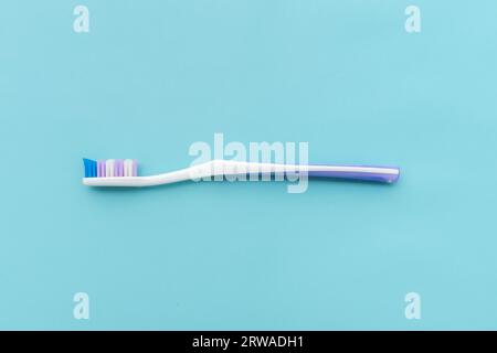 A toothbrush isolated on blue background, after some edits. Stock Photo