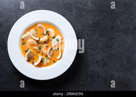 Seafood soup plate on black slate background Stock Photo
