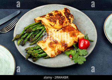 Freshly made omelette cooked with green asparagus for breakfast Stock Photo