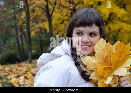 portrait of freckled teenage girl in the autumn park Stock Photo